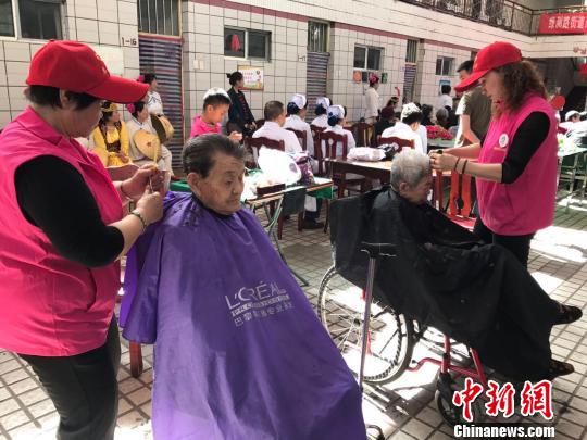 志愿者们为老人梳理头发。迪娜 摄